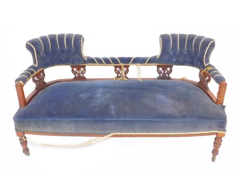 A Victorian walnut two seater sofa, with a pierced open back and button upholstered blue fabric,  over stuffed seat raised on