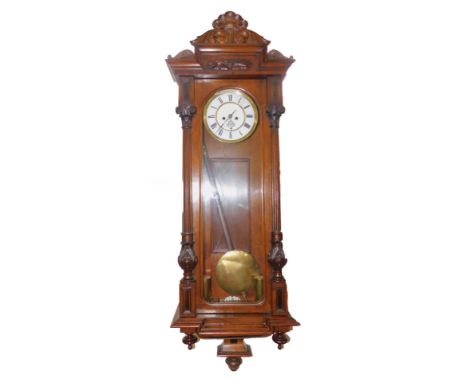 A late 19thC walnut cased Vienna wall clock, circular brass and white enamel dial with chapter ring bearing Roman numerals, e