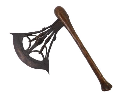 A Songye tribal ceremonial axe, c1900, with a wrought iron blade decorated with three masks, copper club handle, 41cm long.