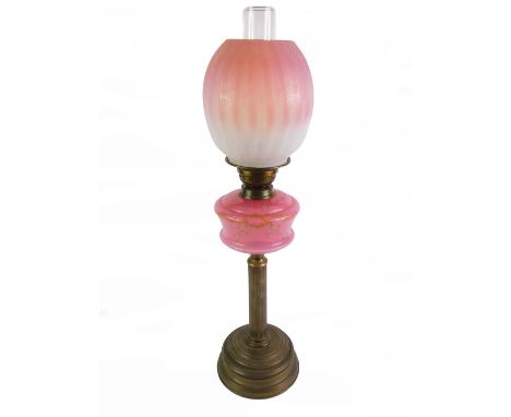 A Victorian brass oil lamp, of fluted column form, with a pink glass reservoir, enamel decorated with Forget-Me-Nots, with ch