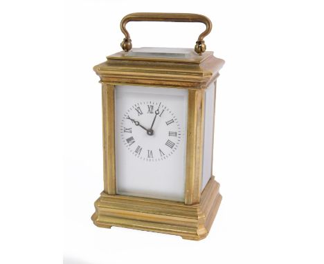 A miniature brass carriage clock, white enamel dial bearing Roman numerals, with key, 8cm H, 5cm W, 4.5cm D.