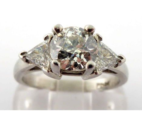 A diamond dress ring, the central old cut brilliant approx. 1.35 carat, claw set above trillion cut shoulders, mounted in whi