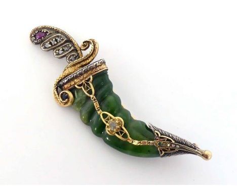 A nephrite, diamond, ruby and sapphire brooch, in the form of a khanjar, with carved nephrite scabbard, to sapphire, ruby and