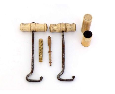 A pair of ivory-handled boot jacks, a bone travelling shaving cream and brush set, a carved ivory needle case with a dragon, 