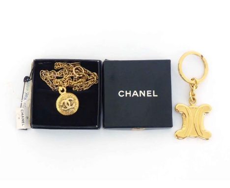 CHANEL, a gilt metal pendant, the round pendant with Chanel monogram, 22mm diameter, to a twist link chain, in its box, toget