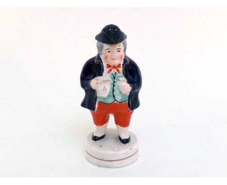 A ceramic Toby Philpott pepper, the figure in traditional stance holding jug and glass, the tricorn hat pierced to dispense t