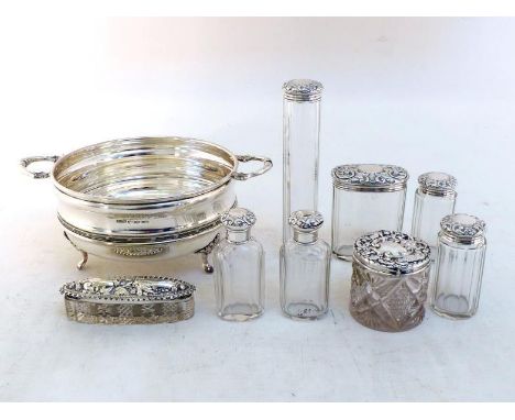 A group of six late Victorian silver-mounted fluted glass dressing table bottles byThomas Ingleton, London, 1894, chased with