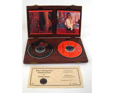 Bruce Springsteen. Two mahogany boxes , each with two compact discs of Bruce Springsteen's hits "Human Touch" and "Lucky Town