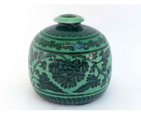 A Chinese ceramic 'Cizhou' ware jar, in the compressed form of Meiping, decorated with scrolling lotus in the centre and leav