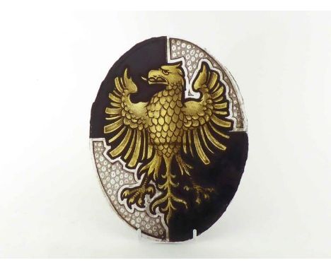An 18th. century or earlier armorial stained glass oval panel of an eagle displayed, gold, with magenta cut card overlay to t