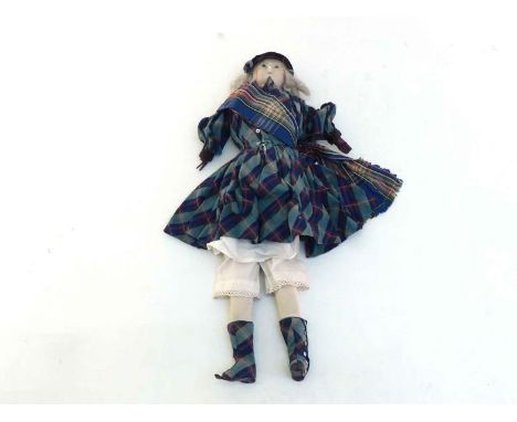 A Victorian wax headed doll in highland dress with blonde hair, blue ceramic eyes,  black velvet trimmed tartan  Balmoral bon