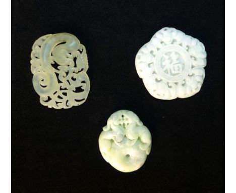 Three Chinese white jade pendants; pentagon with bats and central character marks, 5cm w, a dragon amongst foliage, 5cm h, an