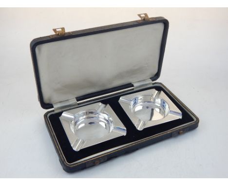 Pair of 1940's silver ashtrays with engine turned decoration, cased.