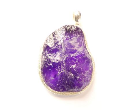 Natural amethyst, silver pendant of asymmetrical form with hammered mount.