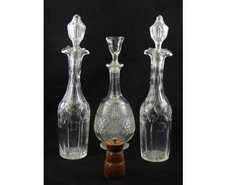 A pair of Edwardian decanters of mallet form, double spout, faceted diamond and circle cut, H. 37cm, another decanter with fl