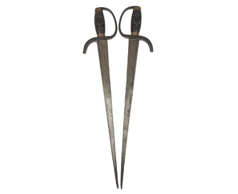 A pair of Chinese fighting knifes, tapering blades of stout cross section 18.5 in., brass knuckle bows extending to form droo