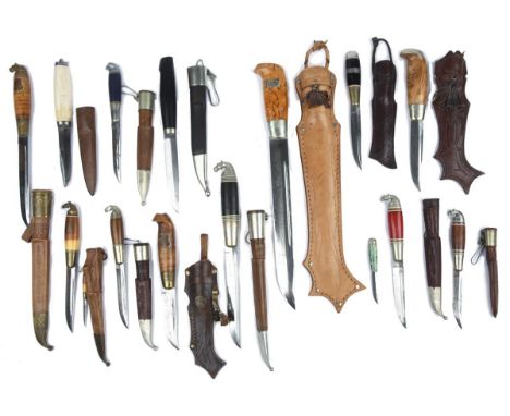 λ A collection of Finnish knives (puukko), in various sizes and with mountings in various materials, scabbard enclosing the l