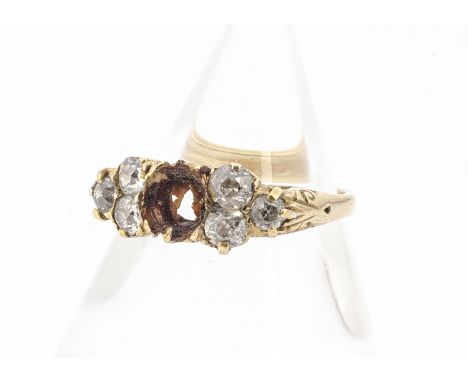 An 18ct gold diamond ring, with central setting vacant, the three old cut diamonds set to each shoulder in a scroll setting, 