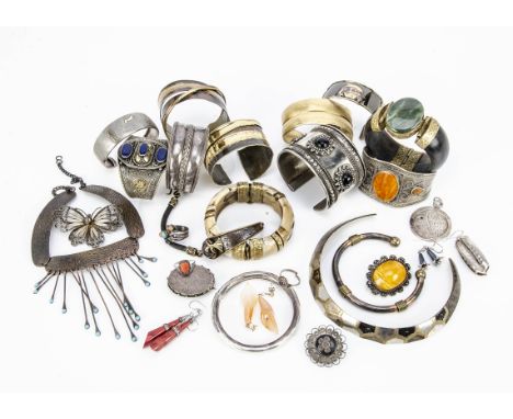 A collection of white metal and base metal bangle, some set with hardstones, together with butterfly brooches in filigree, co