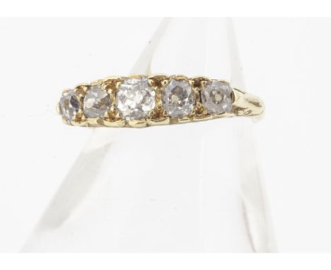 An 18ct gold five stone diamond ring, the old cut diamonds in claw settings with scroll gallery, ring size K, total diamond w