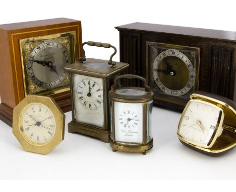 Six vintage and modern timepieces, including a damaged carriage timepiece, a smaller oval carriage clock, a Westclox travel c