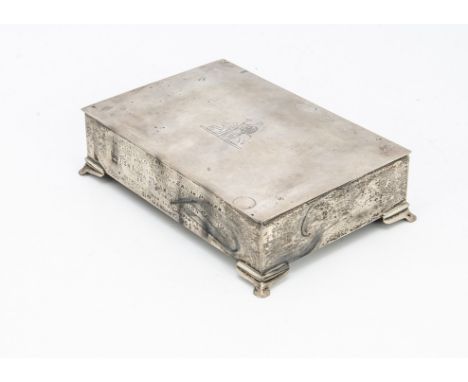 A 1960s silver presentation cigarette box from Alexander Clark &amp; Co, rectangular on bracket style supports, engraved to f