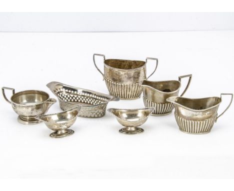 Seven Victorian and later items of silver, including a pierced dish, sugar basin, three milk and cream jugs and a pair of sal