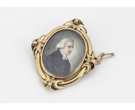 A 19th Century portrait miniature and yellow metal brooch, depicting three quarter length portrait of a robed gentleman withi