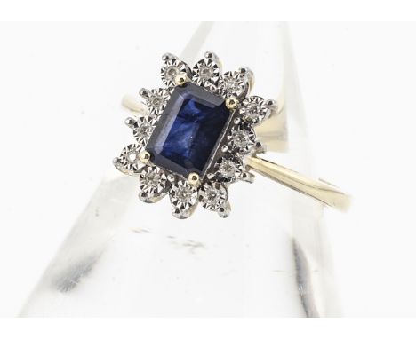 A 9ct gold sapphire and diamond cluster ring, the step cut claw set sapphire surrounded by illusion set diamonds, ring size L