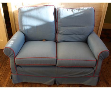 A blue loose cover two seater sofa