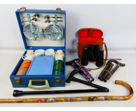 A vintage Braxton picnic set, four walking sticks and a cased pair of binoculars. [W]