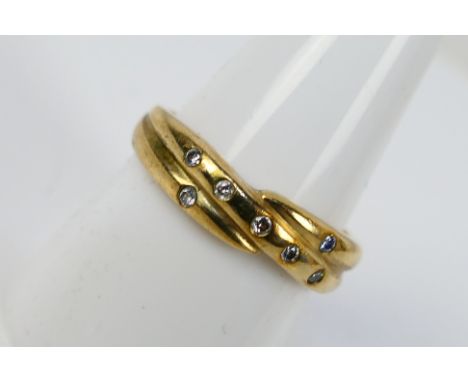 A 9ct yellow gold ring set with seven small diamonds, size R, approximately 4.7 grams. [W]