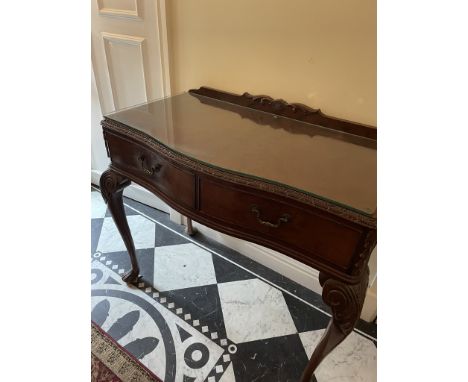 A mahogany twin drawer hall table with serpentine front and protective glass top, approximately 83 cm x 97 cm x 52 cm.

NOTE: