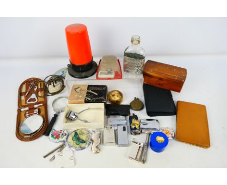 A mixed lot of collectables to include travel grooming kit, cigarette lighters, trinket boxes and other. [W]