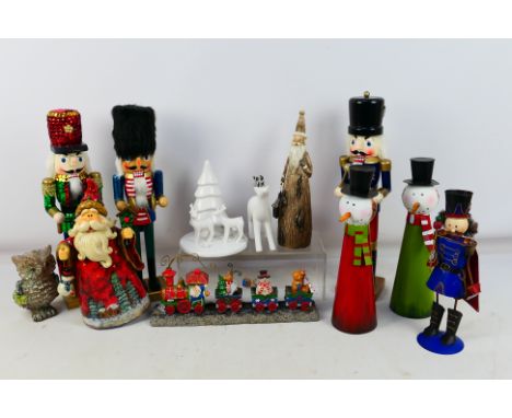 An assortment of mixed Christmas ornaments to include a Santa, resin Christmas Express, a tin soldier Nutcrackers and others.