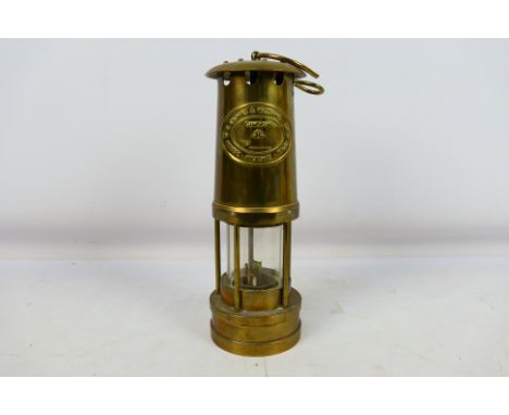 A brass vintage miner's lamp by E. Thomas and Williams Ltd. The Welsh Cambrian lamp is numbered 134164. Appears to be in very