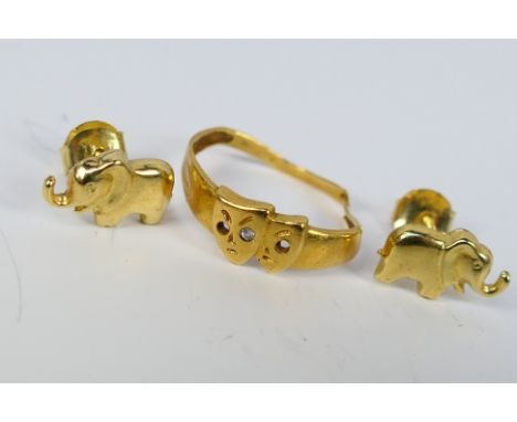A pair of yellow metal earstuds in the form of elephants, the butterflies stamped 585 and a yellow metal ring (shank cut), ma