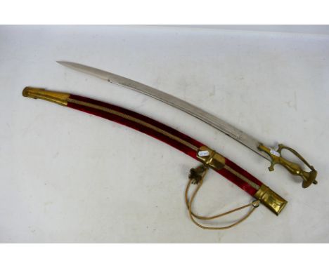 An ornamental talwar type sword with brass hilt and 63 cm (l) single edge curved blade. [W]

Note: This lot is not for sale t