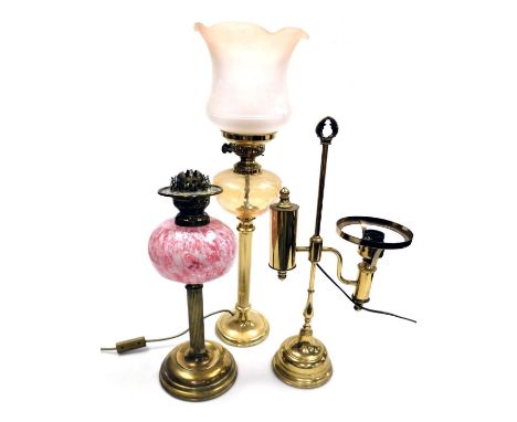 An early 20thC cranberry glass and brass oil lamp, the reservoir decorated with white opaline and aventurine, no chimney or s