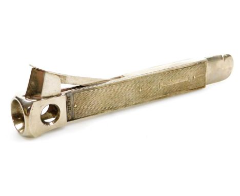 An Elizabeth II silver cigar cutter, with engine turned decoration, Birmingham 1971, 3.82oz. 