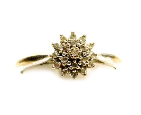 A platinum and diamond flower head ring, of three tier form, in a basket mount, set with nineteen tiny diamonds, size O 1/2, 