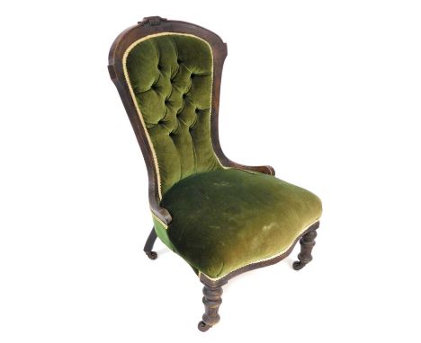 A Victorian mahogany spoon back nursing chair, upholstered in button back green draylon, raised on turned legs.