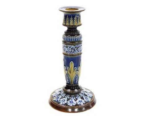 A late 19thC Doulton Lambeth stoneware candlestick, moulded with repeating bands of leaves and flowers, impressed and incised