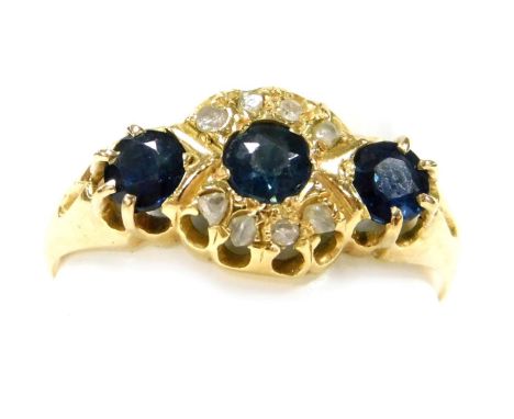 A 18ct gold three stone sapphire and diamond ring, in a claw mount, size N, Chester 1912, 2.19g.