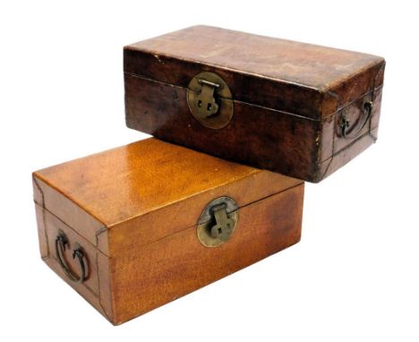 Two late 19thC Oriental leather trunks, each with brass ring handles and lock plate, 32cm wide and 31cm wide. 