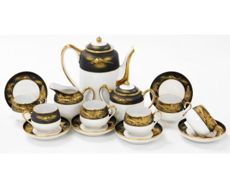 A 20thC Japanese eggshell porcelain coffee service, decorated with a band of matt black with gilt highlights depicting buildi