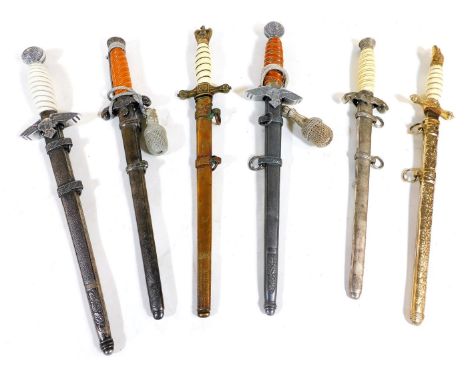 Six reproduction German daggers, including a second pattern Luftwaffe dagger, a Kriegsmarine officer's dagger, and an army of