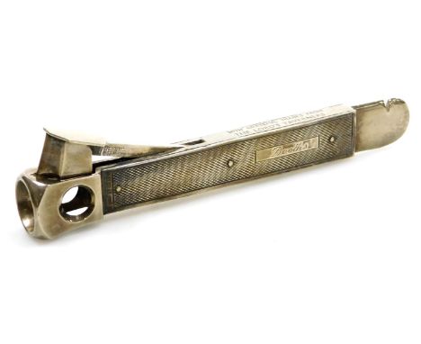 An Elizabeth II silver cigar cutter, with engine turned decoration, rectangular reserve engraved Booths, and to the steel 'Wi