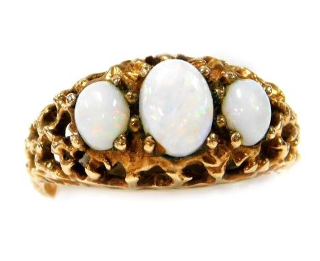 A 9ct gold and opal three stone ring, in a pierced scroll mount, size M, 3.6g.