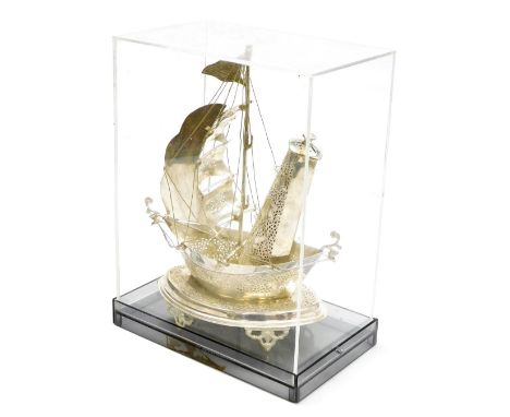 A Middle Eastern white metal model of a Dhow, converted to a table lamp, within a Perspex case, case 30cm x 22.5cm. 